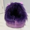 A fuzzy purple slipper with a shiny base.