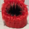 A red furry monster mouth with sharp teeth and a black interior.